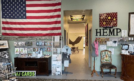 The front room: card racks, the flag, and the hallway through to the studio